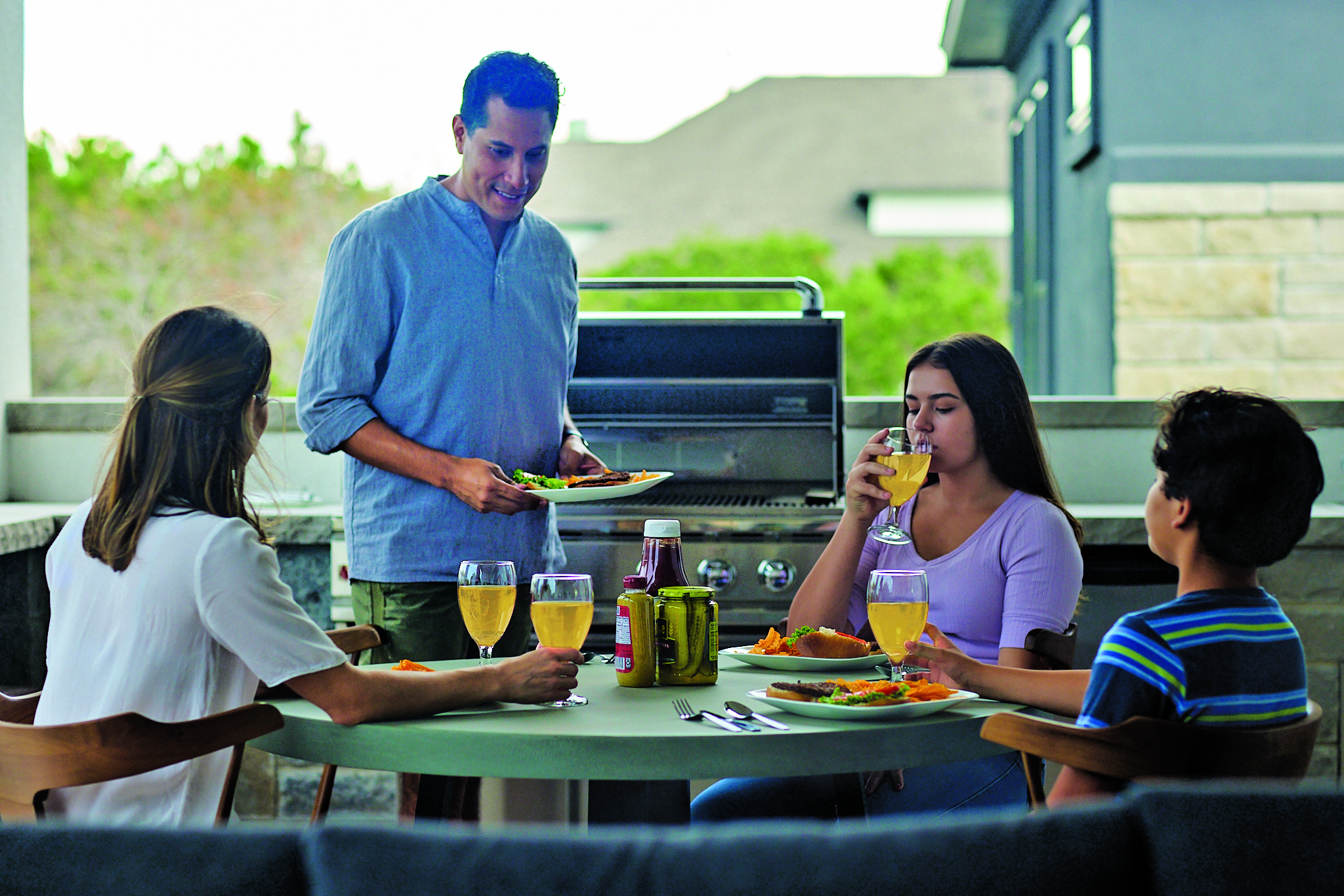 Family enjoying barbecue on porch