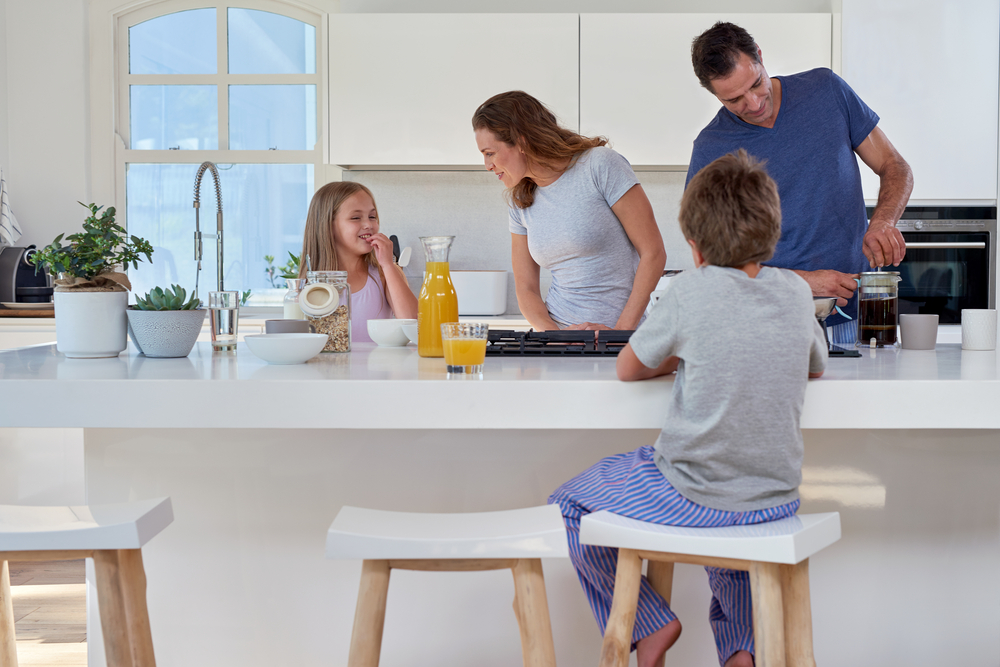 Smiling Family Making Breakfast in the Kitchen